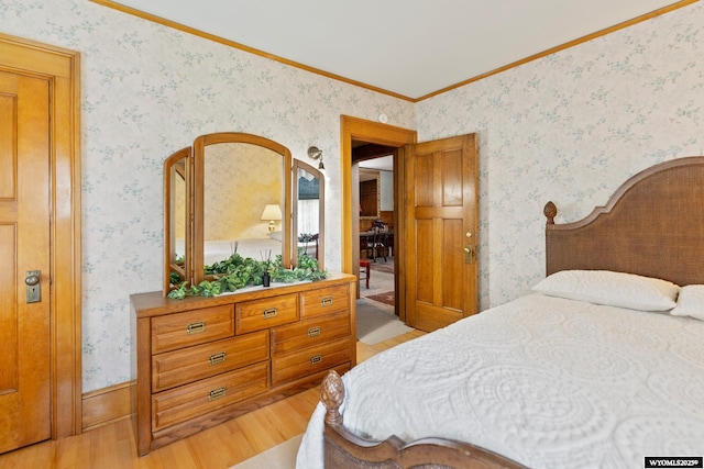 bedroom with crown molding and light hardwood / wood-style floors