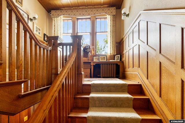 staircase with radiator and wood ceiling