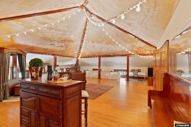 interior space featuring light hardwood / wood-style flooring and lofted ceiling