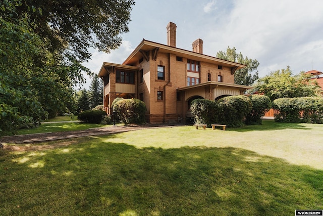 rear view of house featuring a yard