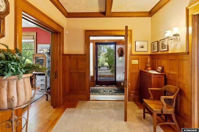 entryway featuring light hardwood / wood-style floors and ornamental molding