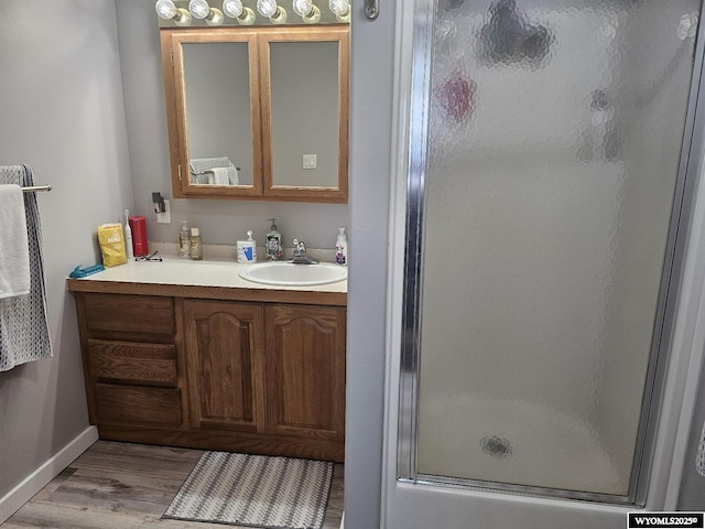 bathroom featuring vanity, hardwood / wood-style floors, and an enclosed shower