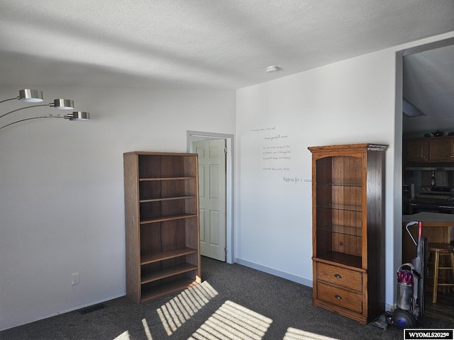 carpeted bedroom featuring a textured ceiling