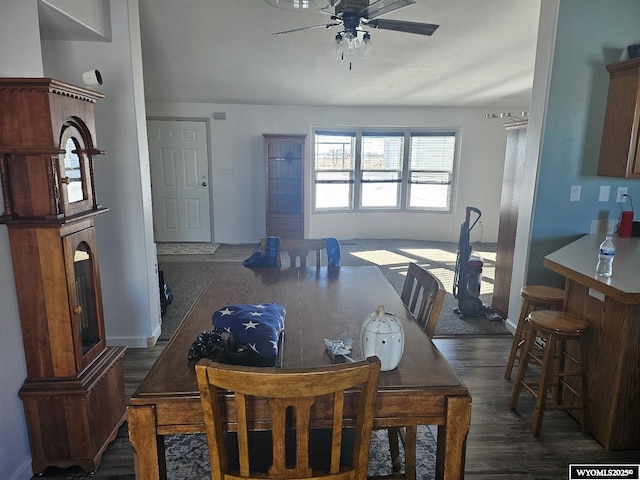 dining area with ceiling fan and dark hardwood / wood-style flooring