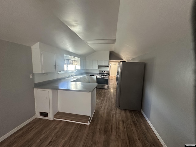 kitchen featuring lofted ceiling, sink, white cabinetry, stainless steel appliances, and kitchen peninsula