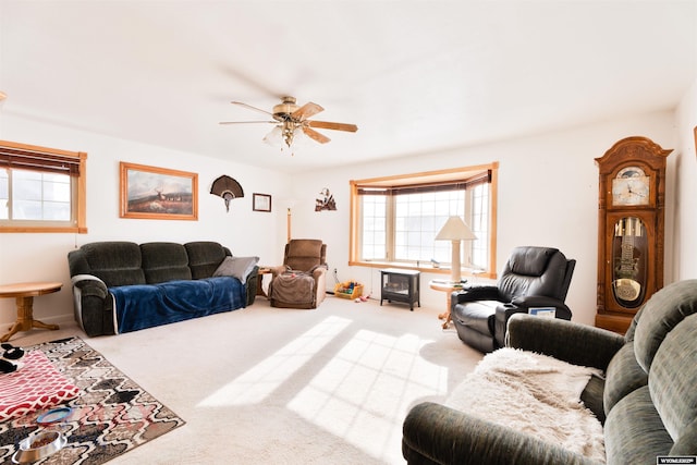 carpeted living room featuring ceiling fan