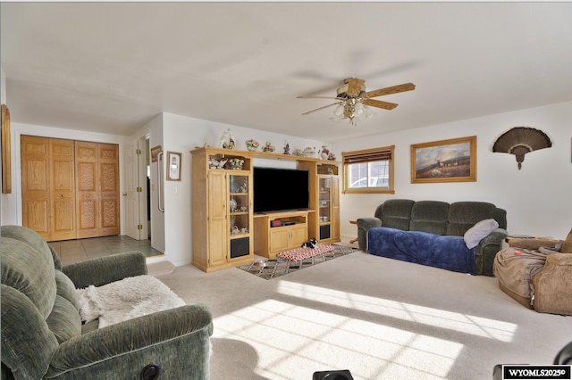 living room featuring light carpet and ceiling fan