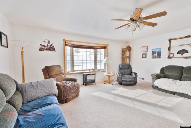 carpeted living room with ceiling fan