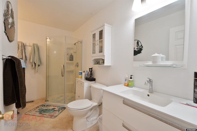 bathroom with walk in shower, vanity, and toilet