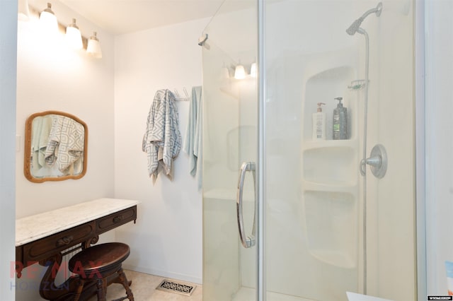 bathroom with an enclosed shower and tile patterned floors