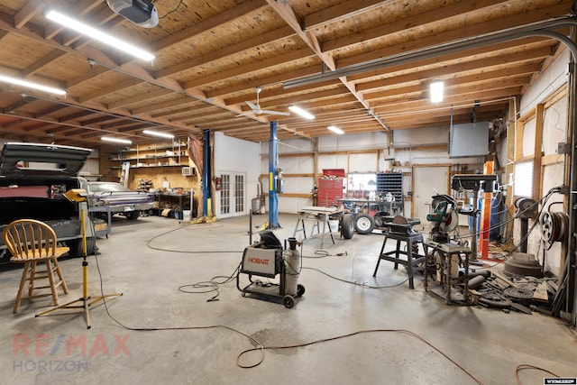 garage featuring a garage door opener and a workshop area