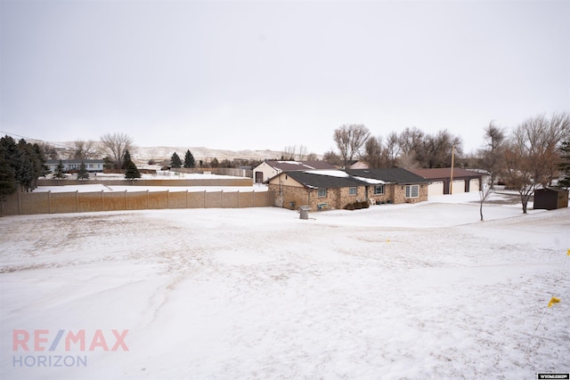 snowy yard featuring a mountain view