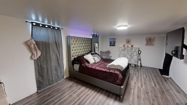 bedroom with hardwood / wood-style flooring