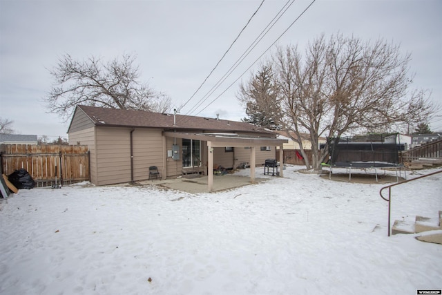 snow covered property featuring a trampoline