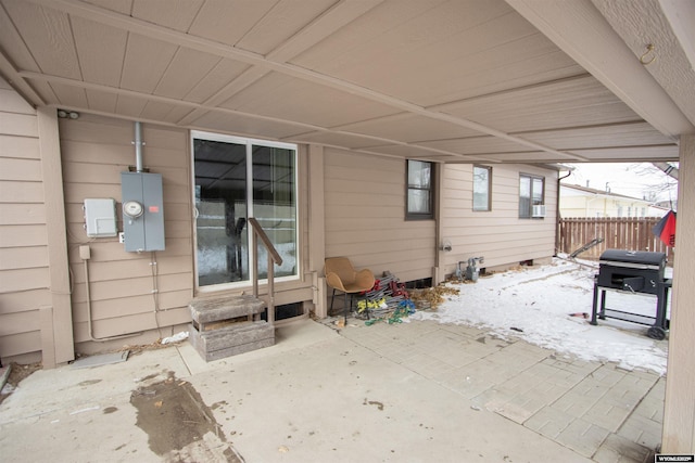 snow covered patio featuring a grill