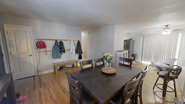 dining area with ceiling fan and hardwood / wood-style floors