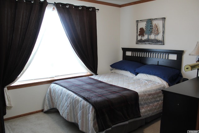 bedroom with baseboards and light colored carpet