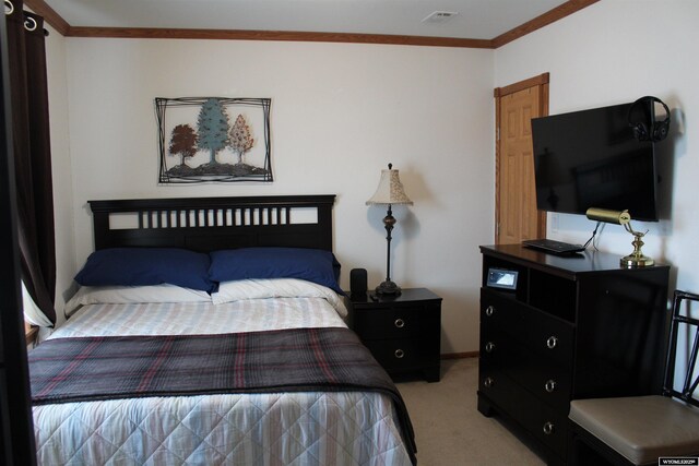 carpeted bedroom featuring ornamental molding, visible vents, and baseboards