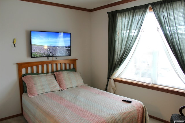 bedroom with carpet floors, baseboards, and ornamental molding