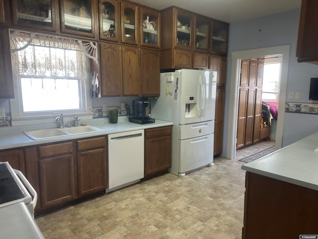 kitchen featuring white appliances and sink