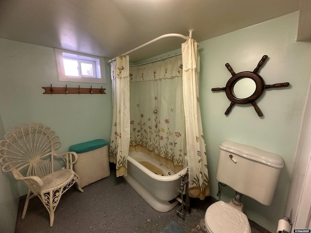 bathroom featuring shower / bath combination with curtain and toilet