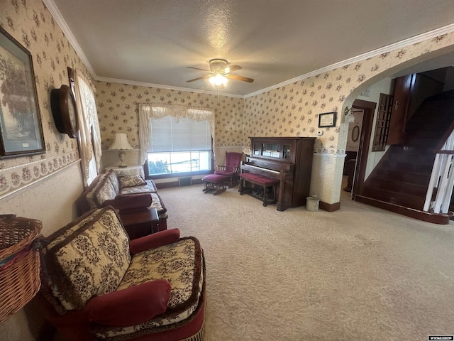 sitting room with crown molding, carpet floors, and ceiling fan