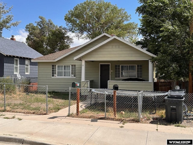 bungalow featuring a fenced front yard