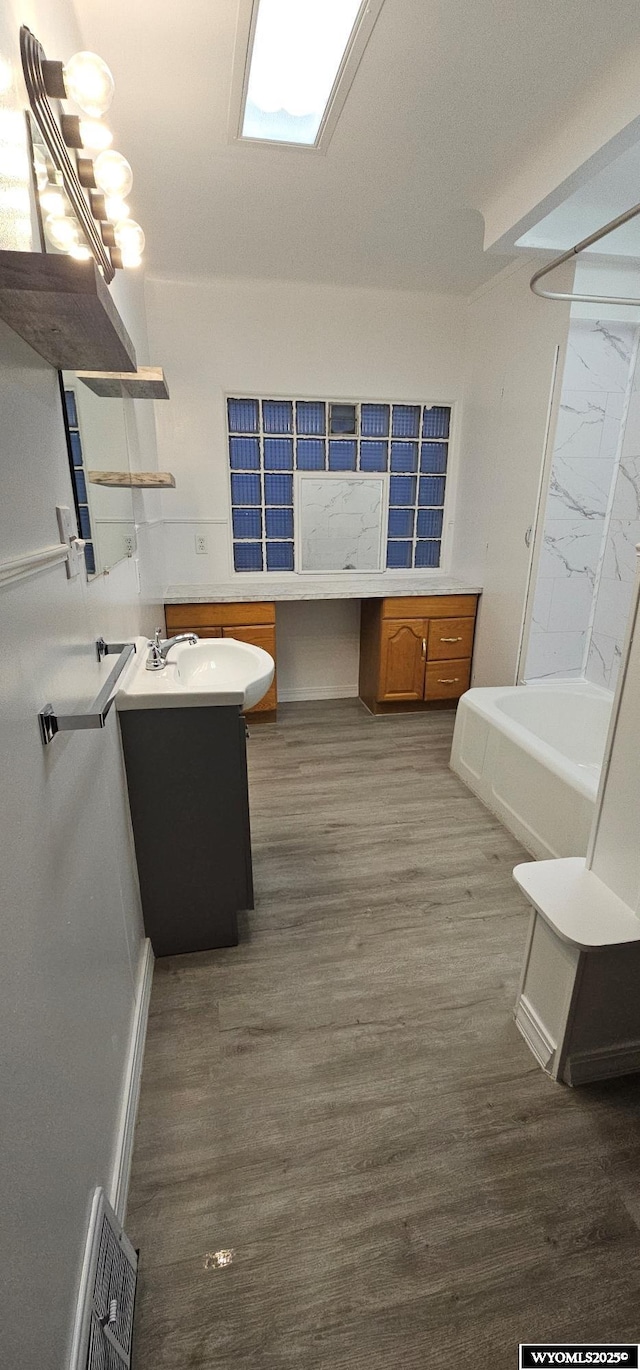 bathroom with visible vents, wood finished floors, and vanity