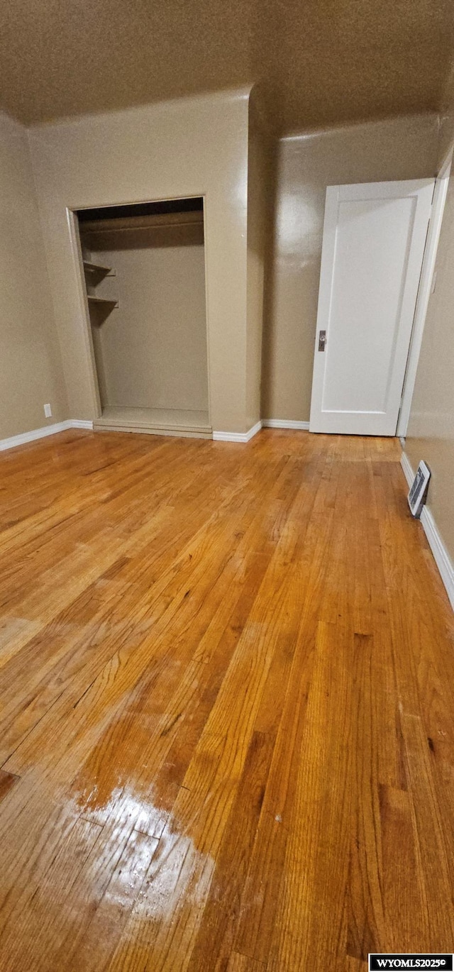 interior space with light wood-type flooring and baseboards