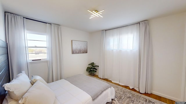 bedroom with hardwood / wood-style flooring