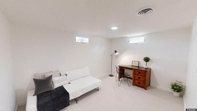 sitting room featuring light colored carpet