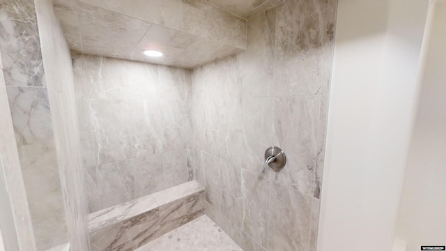 bathroom featuring a tile shower