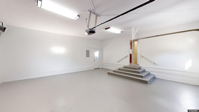 garage featuring a garage door opener and electric panel