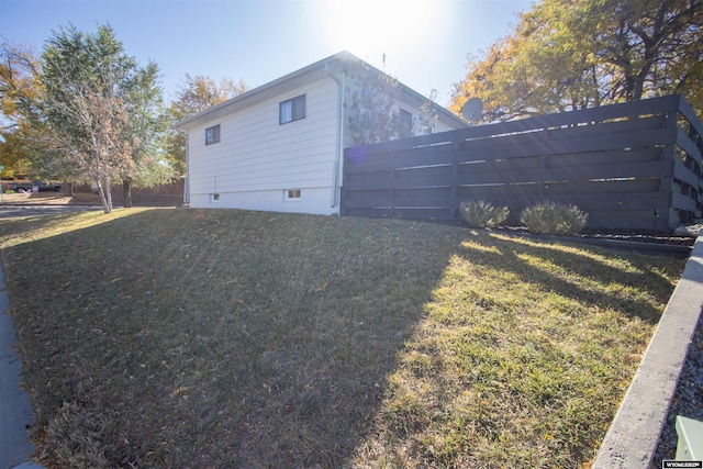 view of side of property featuring a yard