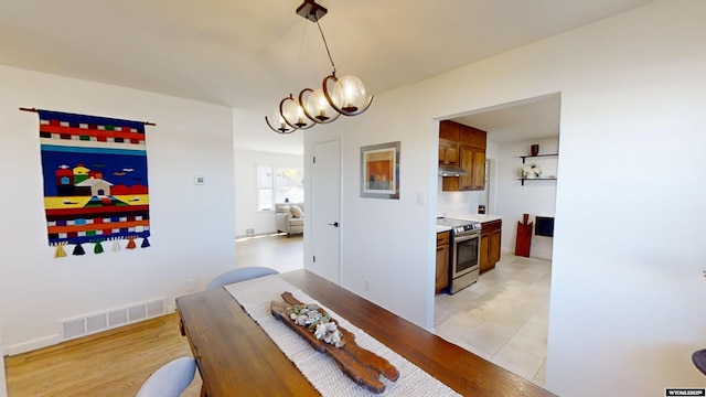 dining area featuring an inviting chandelier