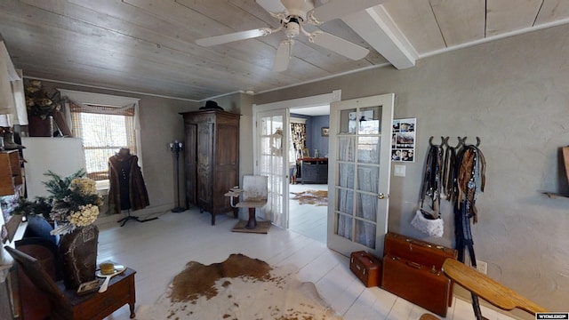 interior space with wood ceiling and ceiling fan