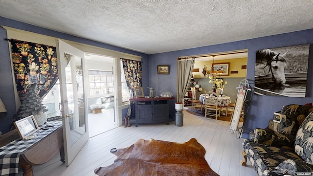 living room with hardwood / wood-style floors and a textured ceiling