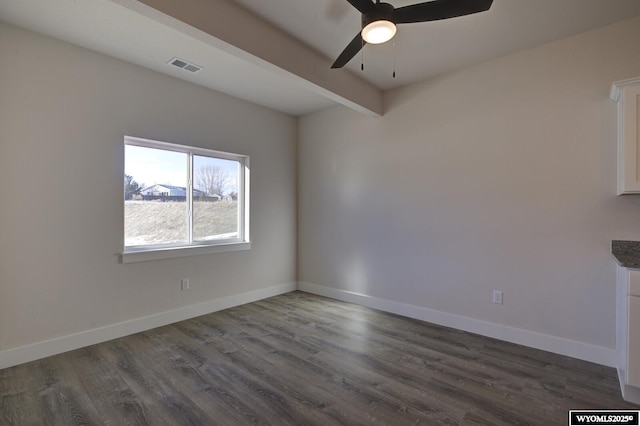 unfurnished room with beamed ceiling, dark wood-type flooring, and ceiling fan