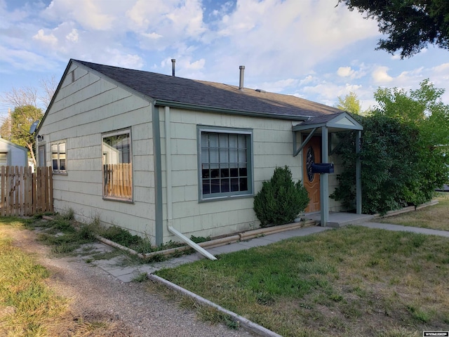 view of side of home with a yard