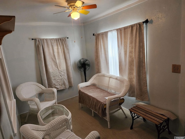 living area featuring ceiling fan