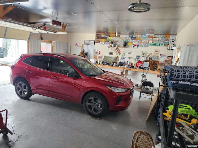 garage featuring a garage door opener and a workshop area