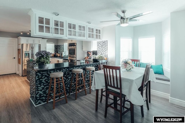 dining area featuring hardwood / wood-style flooring and ceiling fan