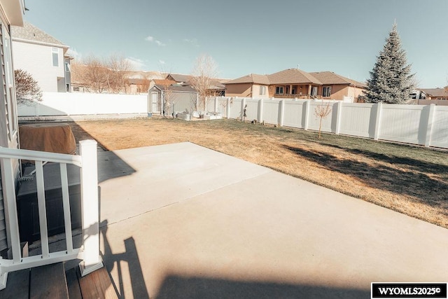 view of yard featuring a storage unit and a patio