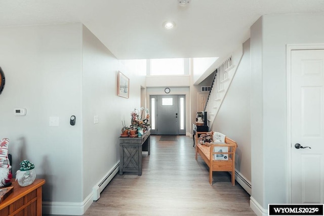 interior space with hardwood / wood-style flooring and baseboard heating