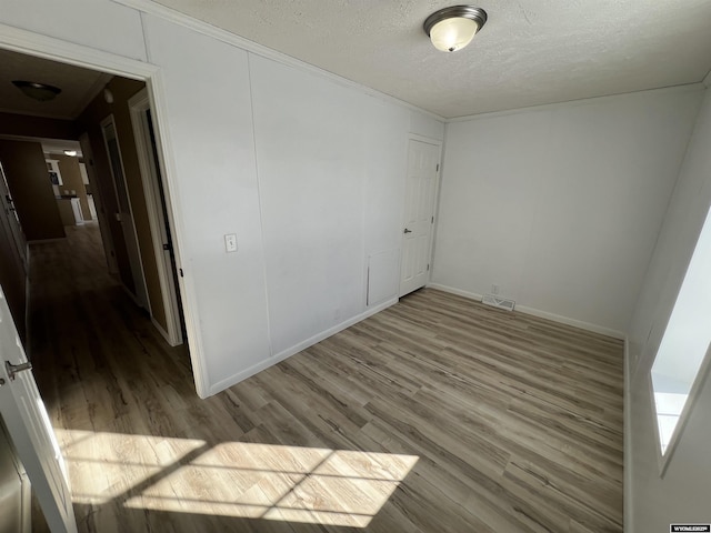 empty room featuring hardwood / wood-style floors and a textured ceiling