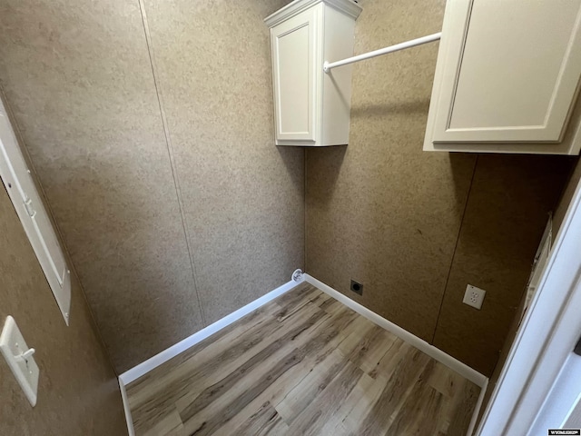 laundry room with light hardwood / wood-style flooring, cabinets, and hookup for an electric dryer