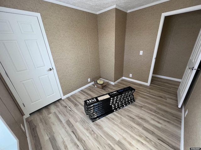 unfurnished bedroom featuring crown molding and light wood-type flooring