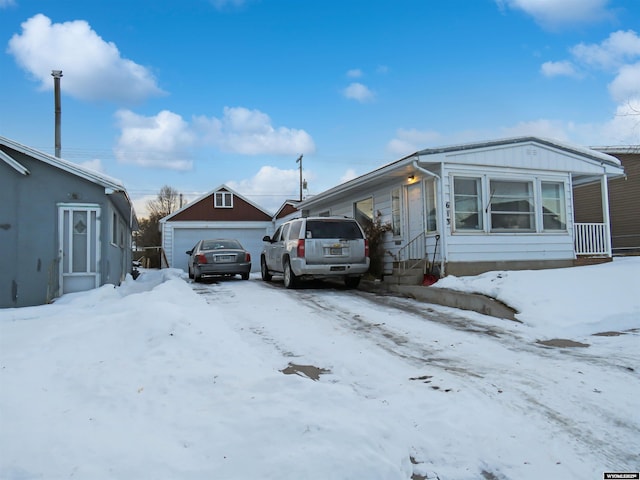 view of front of property featuring a garage and an outbuilding