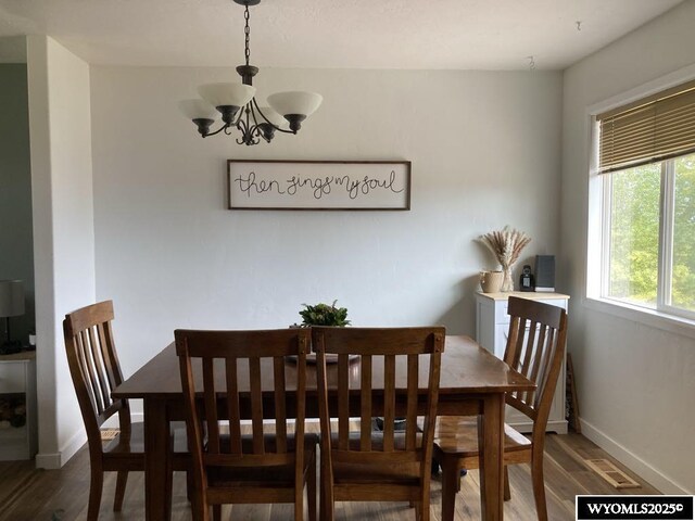 dining area featuring a chandelier and dark hardwood / wood-style flooring