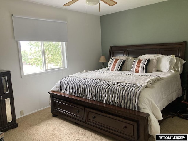 bedroom with ceiling fan and light colored carpet